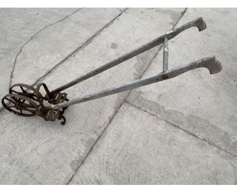 A VINTAGE SEED DRILL (LACKING HOPPER) 