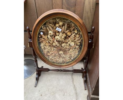A FIRESCREEN, THE OVAL SWING FRAME DECORATED WITH DRIED FLOWERS 