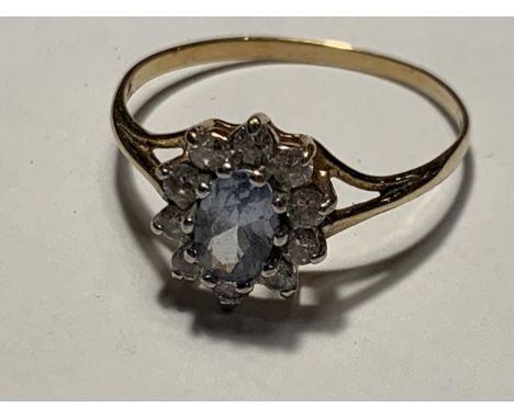 A 9 CARAT GOLD RING WITHB A CENTRE AQAUAMARINE SURROUNDED BY CUBIC ZIRCONIAS  SIZE Q/R 