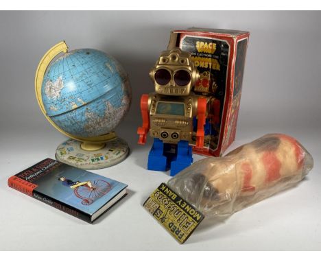 FOUR ITEMS - A BOXED ELECTRONIC SPACE MONSTER, PLASTIC FRED FLINTSTONE MONEY BANK, BOOK &amp; TIN GLOBE 