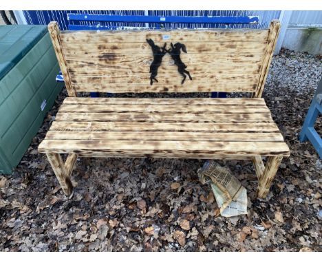 A WOODEN SLATTED GARDEN BENCH WITH PAINTED HARE BACKGROUND 