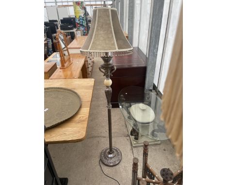 A METAL WARE STANDARD LAMP COMPLETE WITH SHADE 