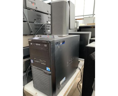 AN ACER COMPUTER TOWER, A COMPUTER MONITOR AND A SPEAKER 