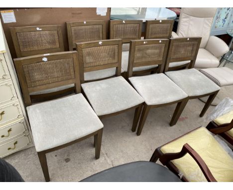 A SET OF EIGHT 'FIRST TIME' DINING CHAIRS WITH UPHOLSTERED SEATS AND DOUBLE CANE BACKS 