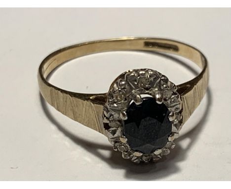 A 9 CARAT GOLD RING WITH A CENTRE SAPPHIRE SURROUNDED BY DIAMONDS SIZE SIZE Q 