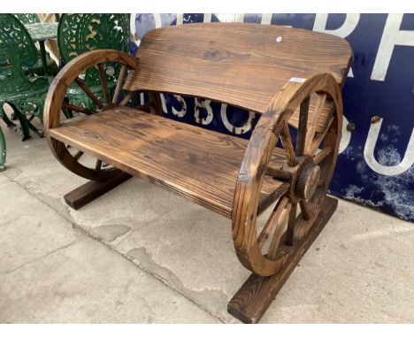 A WOODEN GARDEN TWO SEATER BENCH WITH CART WHEEL BENCH ENDS (L:98CM) 