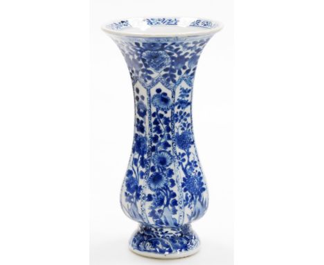 A Chinese blue and white Kangxi beaker vase, decorated with panels of chrysanthemum branches between floral bands, floral mar