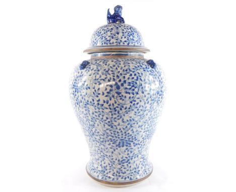 A Chinese blue and white porcelain baluster jar and cover, the cover with dog of fo finial, decorated with flowers and scroll