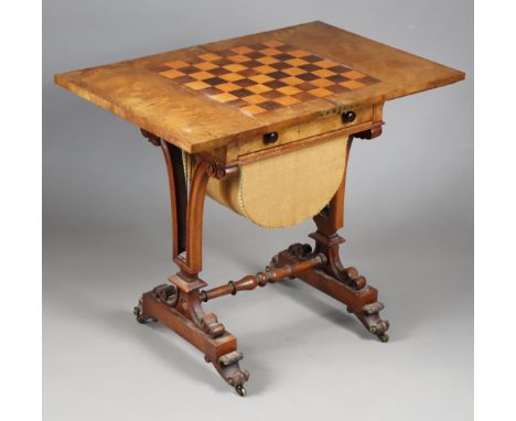 A 19th century games/needlework table with inlaid chessboard to the rectangular fold-over top, fitted frieze drawer above a b