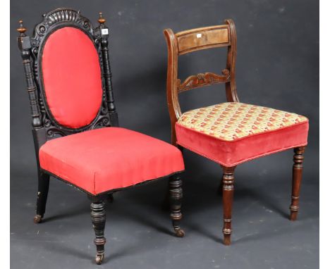 A 19th century ebonised &amp; carved wooden-frame nursing chair with a padded seat &amp; back, &amp; on ring-turned tapered l