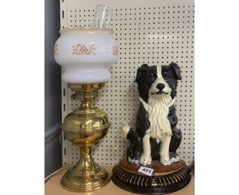 A painted cast iron door stop and an oil lamp style table lamp.