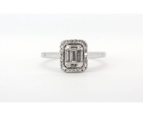 An 18ct white gold ring set with baguette and brilliant cut diamonds, (K).