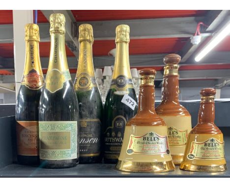 Three bottles of vintage champagne and three empty Bell's Wade whiskey bottles.