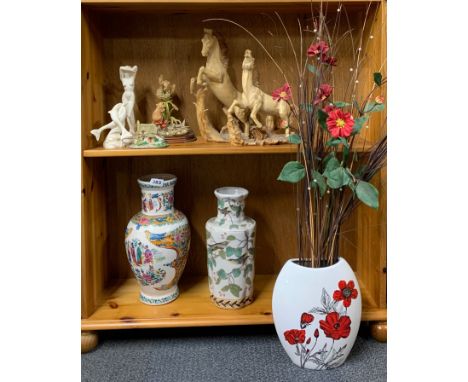 A group of three ceramic vases and a group of figures.
