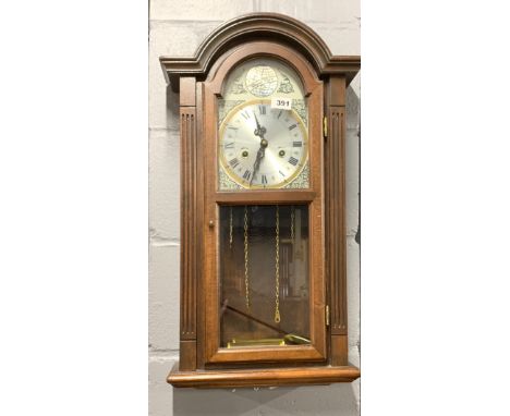 A striking wall clock, H. 69cm.