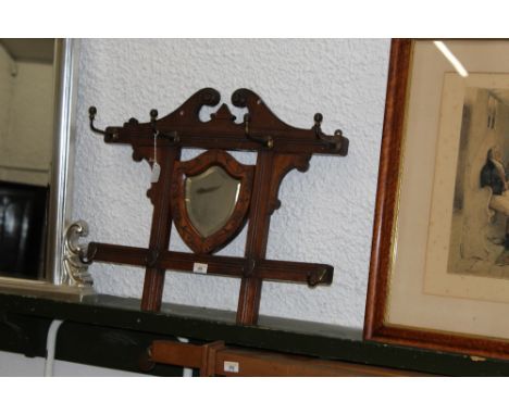 A late 19th century mahogany hat and coat stand with integral mirror 