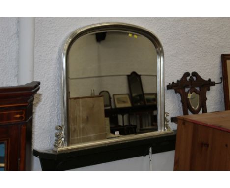 A modern overmantle mirror with silver coloured frame and bevelled plate  