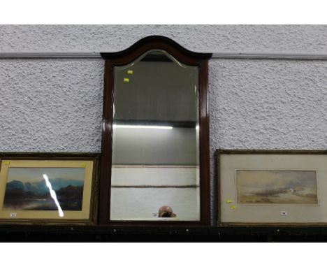 A mahogany framed mirror with arched top and bevelled plate 