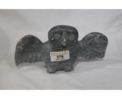A carved stone owl with label to the bottom, Canadian Eskimo Art 
