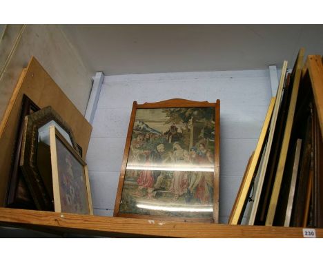 A shelf of framed pictures, mirror etc.