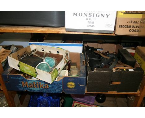 A shelf of miscellaneous, including a box of cameras and cases