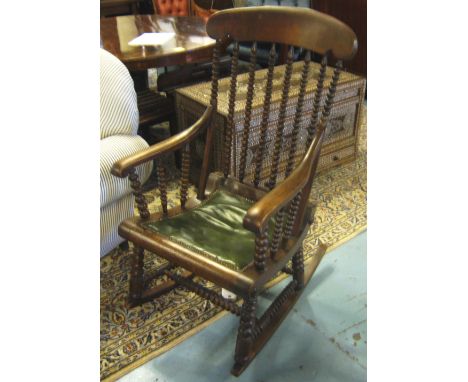 ROCKING CHAIR, late Victorian beechwood with bobbin turned supports and leather padded seat. 