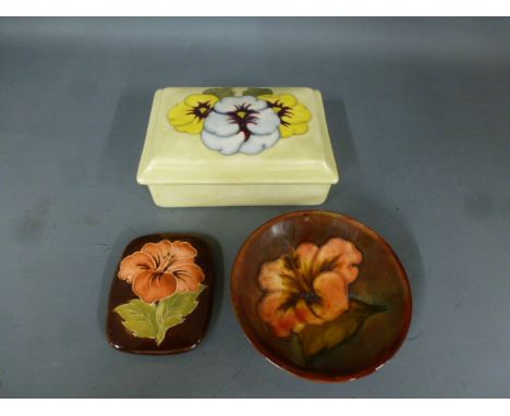 A Moorcroft Hibiscus pattern pin dish and pot lid, design on brown ground - Pin dish diameter 9cm - stamped Moorcroft, made i