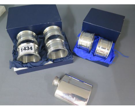 A boxed set of four pewter napkin rings, a pair of similar napkin rings and a small pewter hip flask - all good