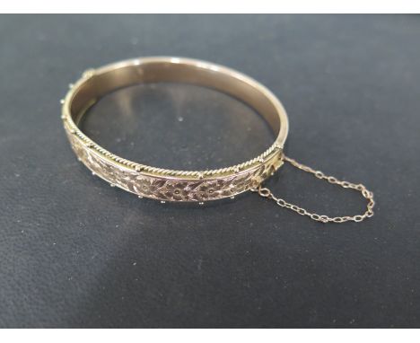 A 9ct gold bangle hallmarked Birmingham 2004 5.5cm x 7cm - approx weight 9 grams - some usage marks and small dents