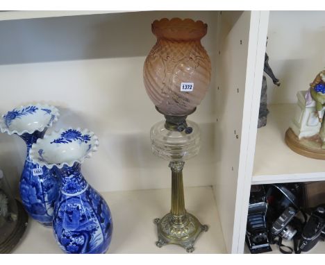 A brass oil lamp with clear font and pink glass shade - Height 73cm