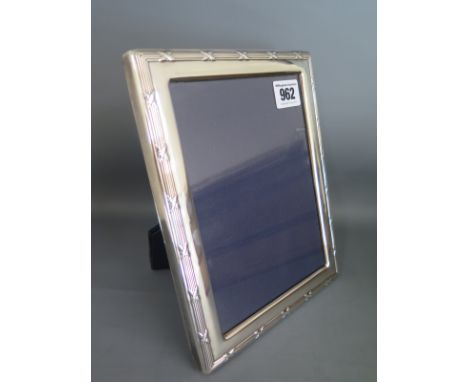 A silver framed photo frame with easel back - 23cm x 17cm - in good condition