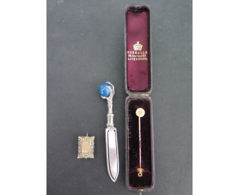A tie pin with a single diamond screw piece believed to be 9ct gold with spare screw head, a small mourning brooch 2cm x 1.5c