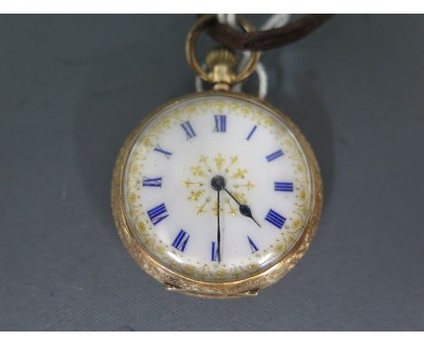 An Edwardian ladies 14ct gold ladies fob watch with white enamel face, blue numerals and gilded decoration - total weight app