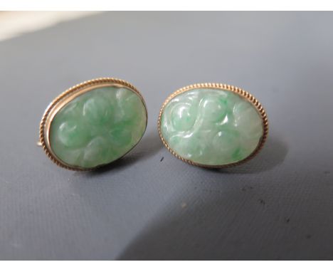 A pair of 9ct gold carved jade screw back earrings