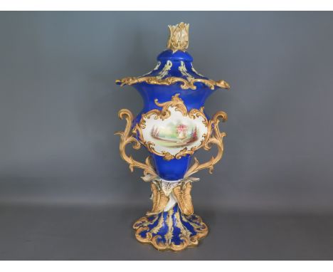 A mid 19th century twin handled vase, tulip finial to lid, blue field with panels back and front with gilt highlights - no ap