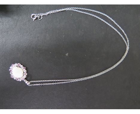 A 9ct white gold opal, pink tourmaline and diamond pendant