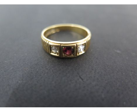 An 18ct gold diamond and ruby three stone ring size L approx weight 4 grams - some usage marks