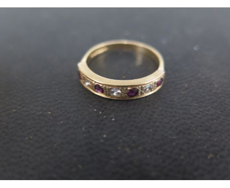 An 18ct gold diamond and ruby seven stone half eternity ring size P - approx weight 3 grams - stones bright, some minor usage