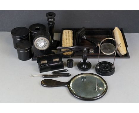 A vintage ebony dressing table set to include brushes, mirror, jars and candlesticks. 