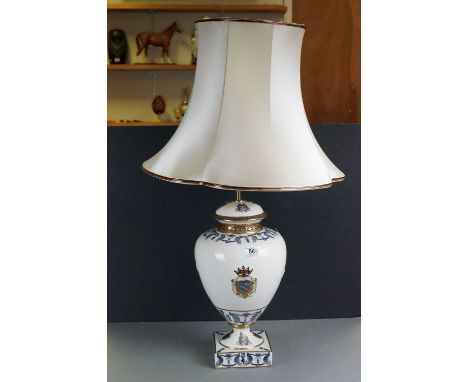 A large ornate ceramic table lamp complete with shade. 