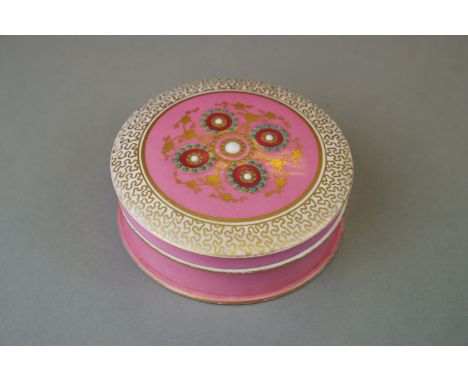 A Continental pink ground ceramic powder pot with stylized floral and gilt decoration. 