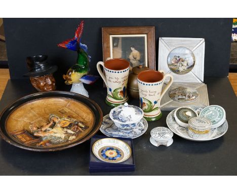 Box of mixed collectables to include a quantity of pot lids, two Torquay Ware mugs, Murano glass fish, Liptons tea caddy etc 