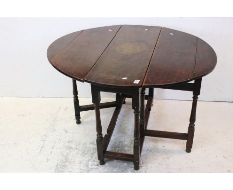 Oak Oval Gate-leg Table raised on turned and block supports, 100cms long x 71cms high 