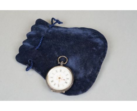 A antique ladies silver cased fob watch with white enamel dial with ornate decoration. 