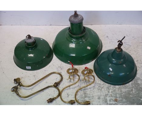 A group of three green enamel industrial light fittings together with four brass wall light fittings. 