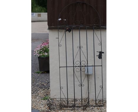 A wrought iron garden gate, measures approx 182cm in height. 