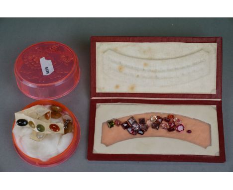 A collection of loose cut gemstones to include lavender jade, green jade and orange jade. 