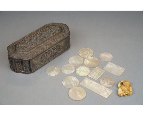 A white metal trinket box containing a quantity of mother of pearl gaming tokens and a netsuke. 