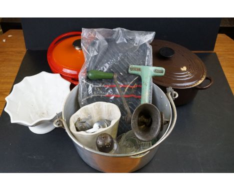 A group of kitchenalia to include enamel casserole dishes, mincer and jelly mould. 