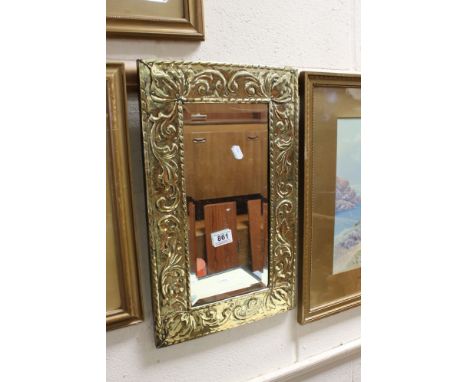 Arts and Crafts Brass Framed Mirror with embossed scroll decoration, 51cms x 31cms 